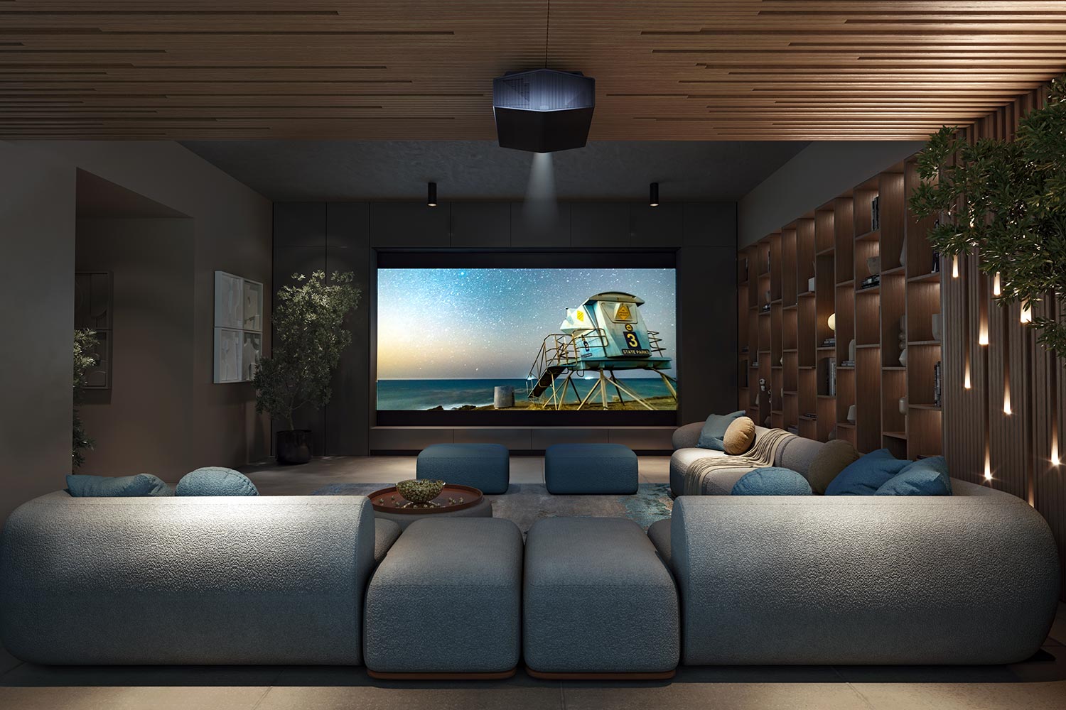 A contemporary home theater with a plush blue sectional sofa, ambient lighting, and a ceiling-mounted projector, creating a modern entertainment space.