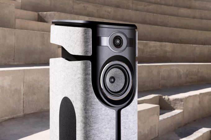 Outdoor shot of a grey and black speaker placed on concrete steps