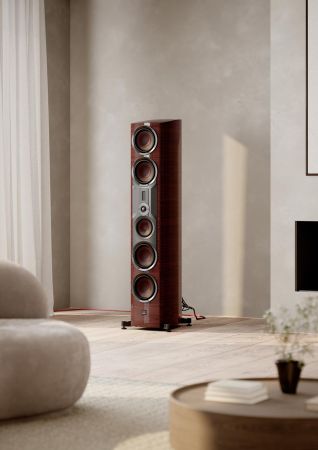 Floorstanding speaker with wood finish in a soft lit living room