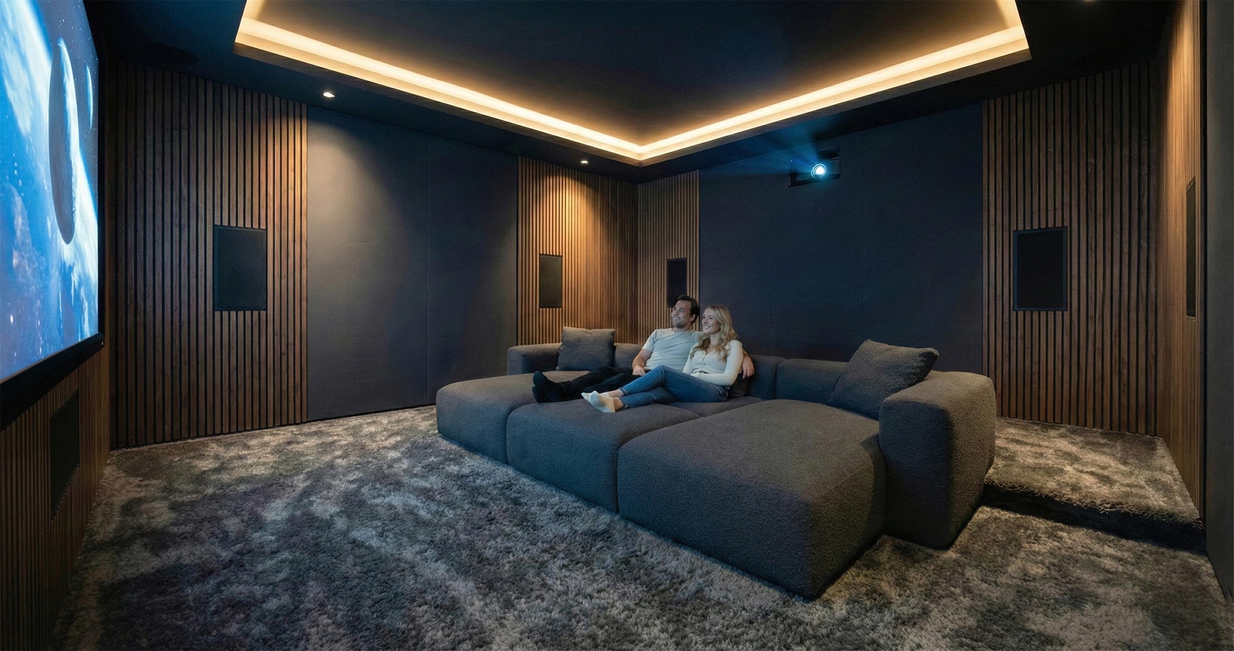 Modern home theater with a large projection screen and plush sectional seating